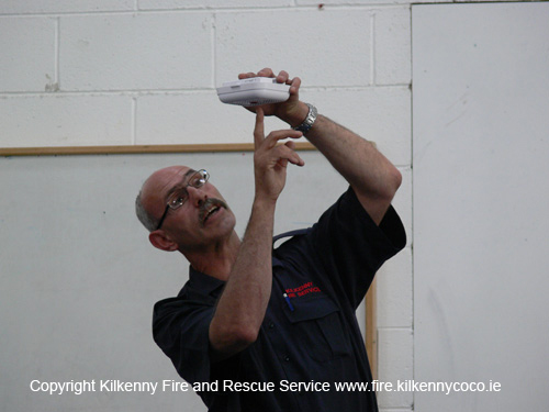 Firefighter demonstrates how a smoke detector works